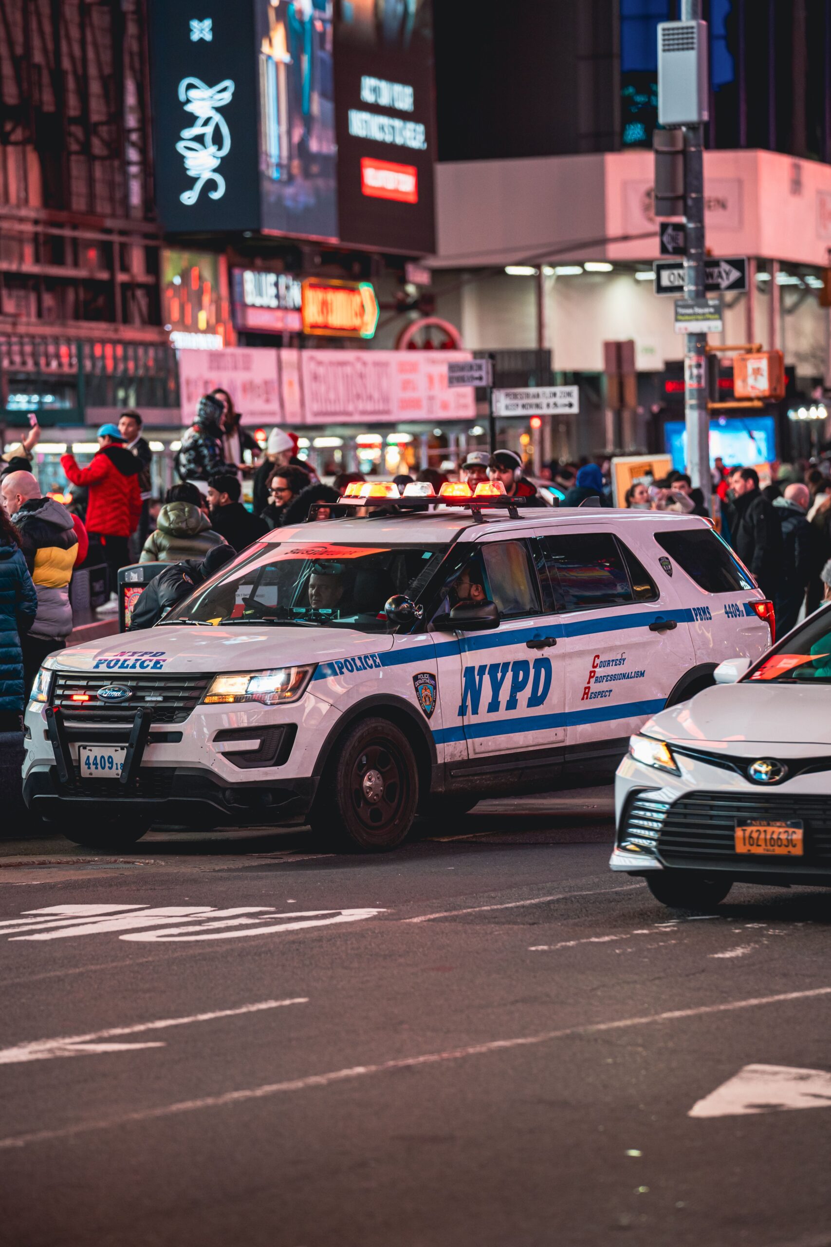 Police patrol car on a city street at night
