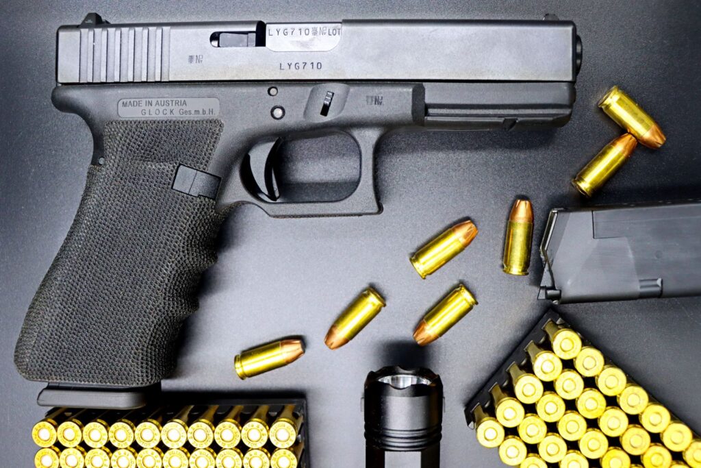 Glock striker-fired pistol disassembled view with cartridges, no external hammer