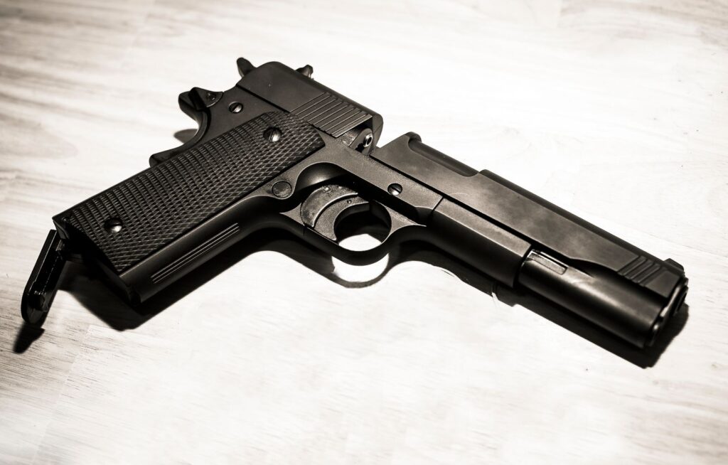 Classic 1911-style hammer-fired pistol with visible external hammer