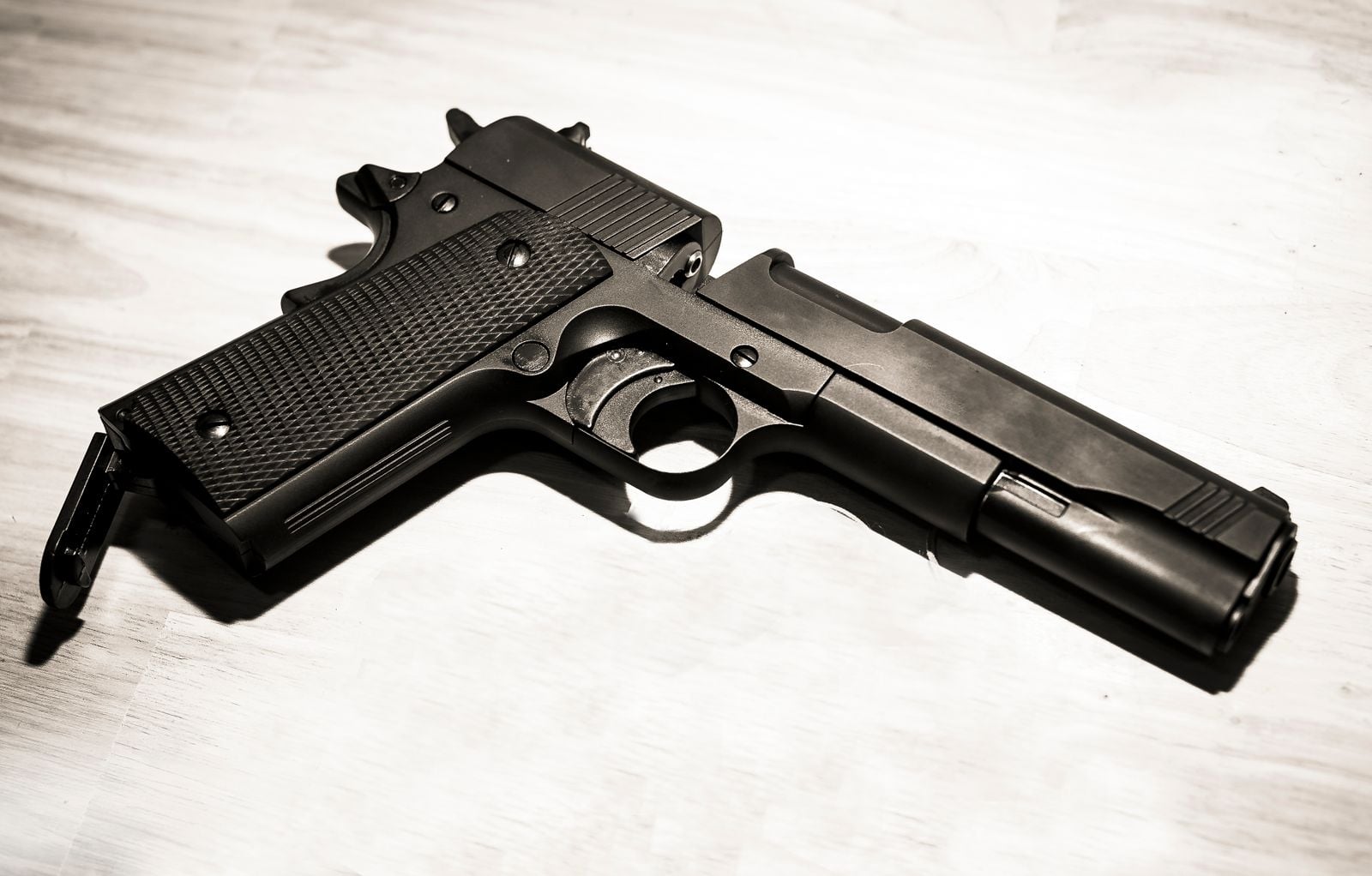 Classic 1911-style hammer-fired pistol with visible external hammer