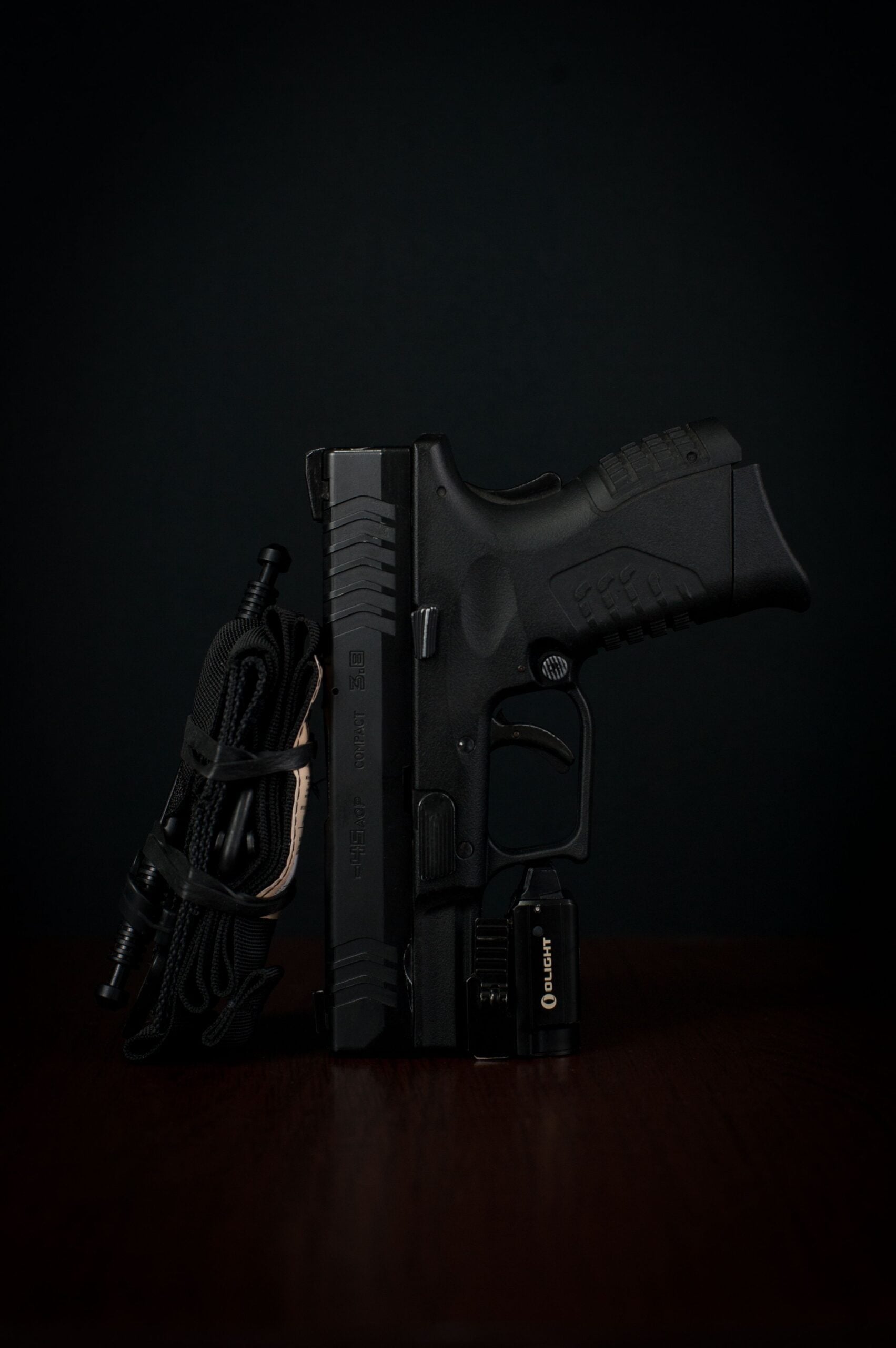 Black semi-automatic pistol on a dark background