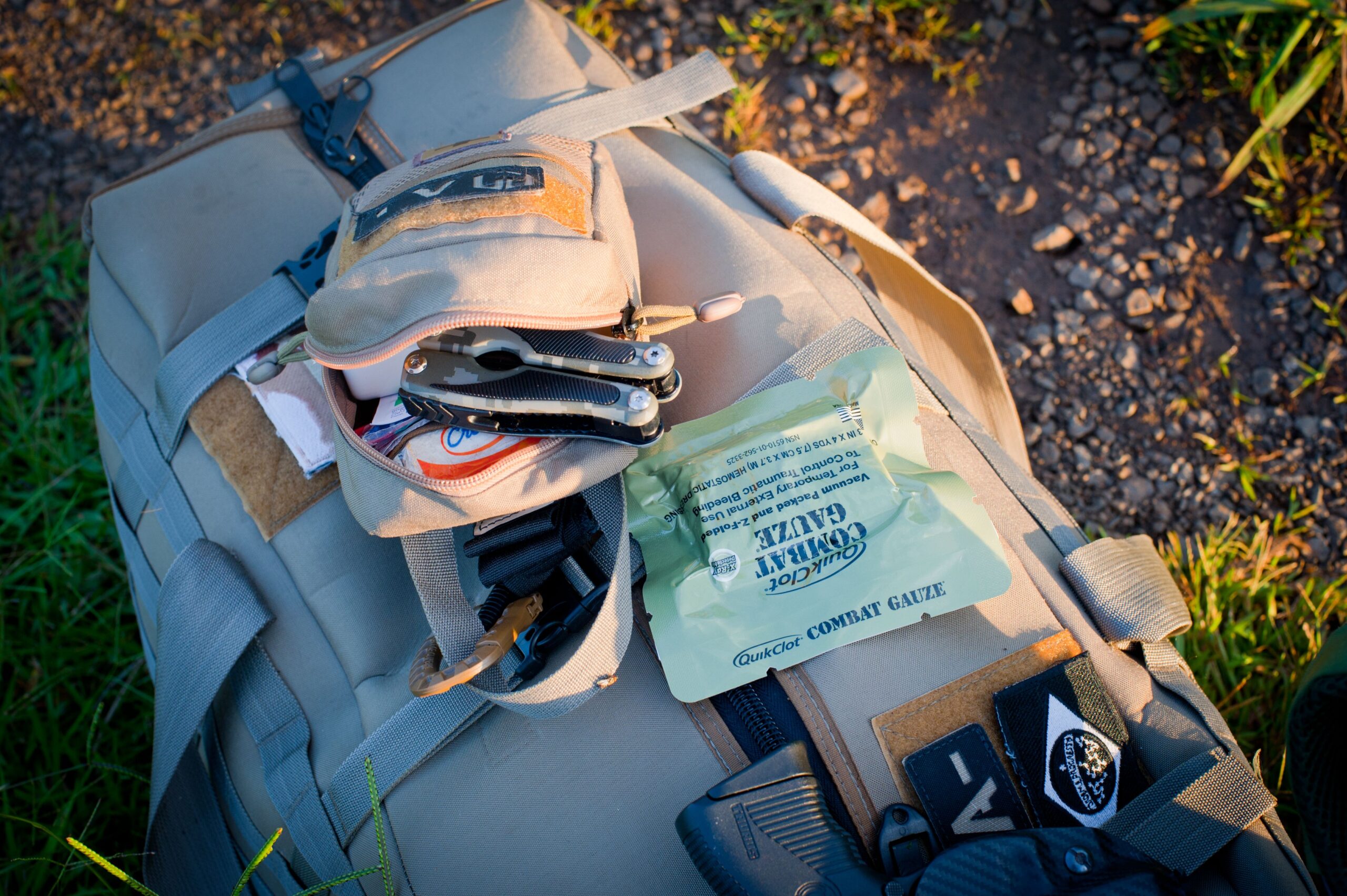 Backpack and survival gear laid out, landscape view