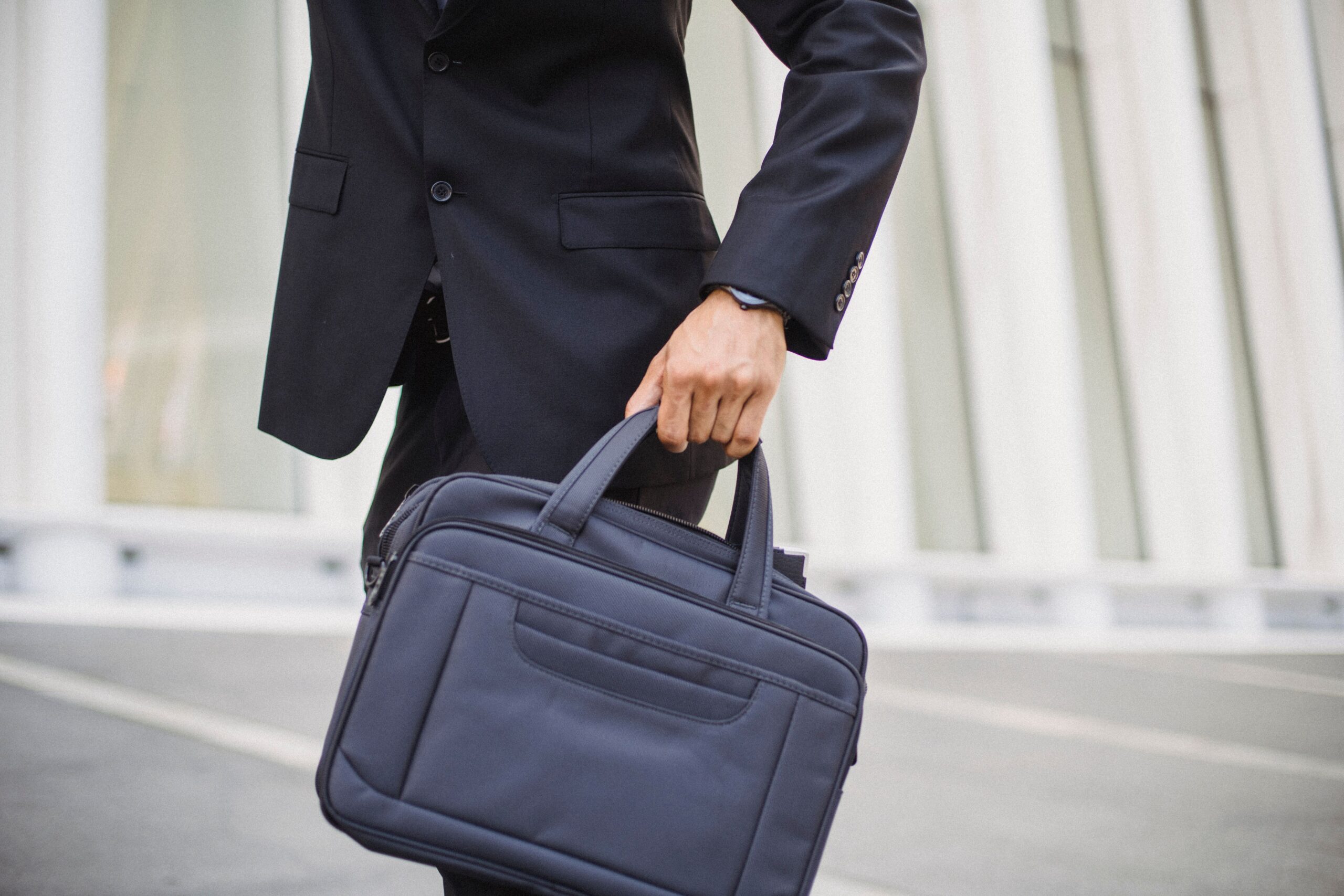 Businessman carrying a briefcase in an urban setting, landscape view