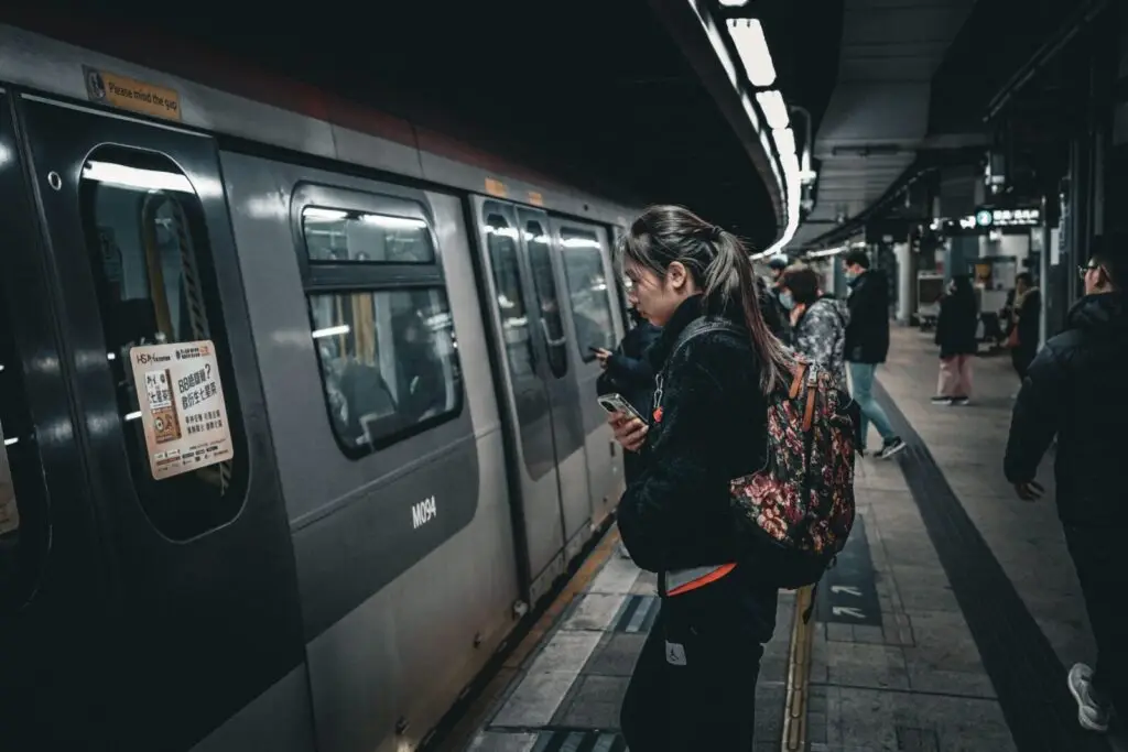 Commuters boarding a subway train at an underground station, showcasing public transit dynamics.