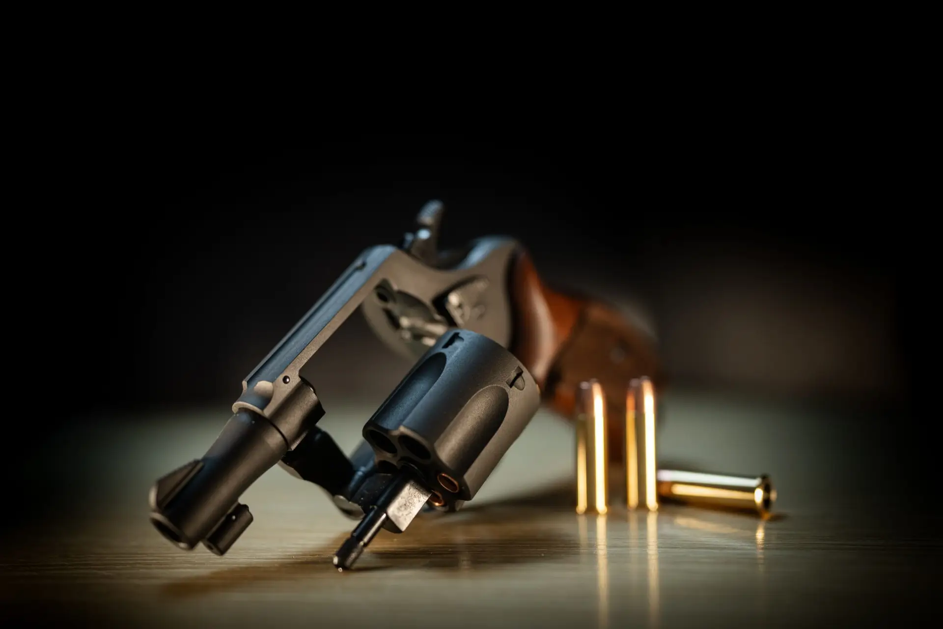 Close-up of a revolver and ammunition on a table