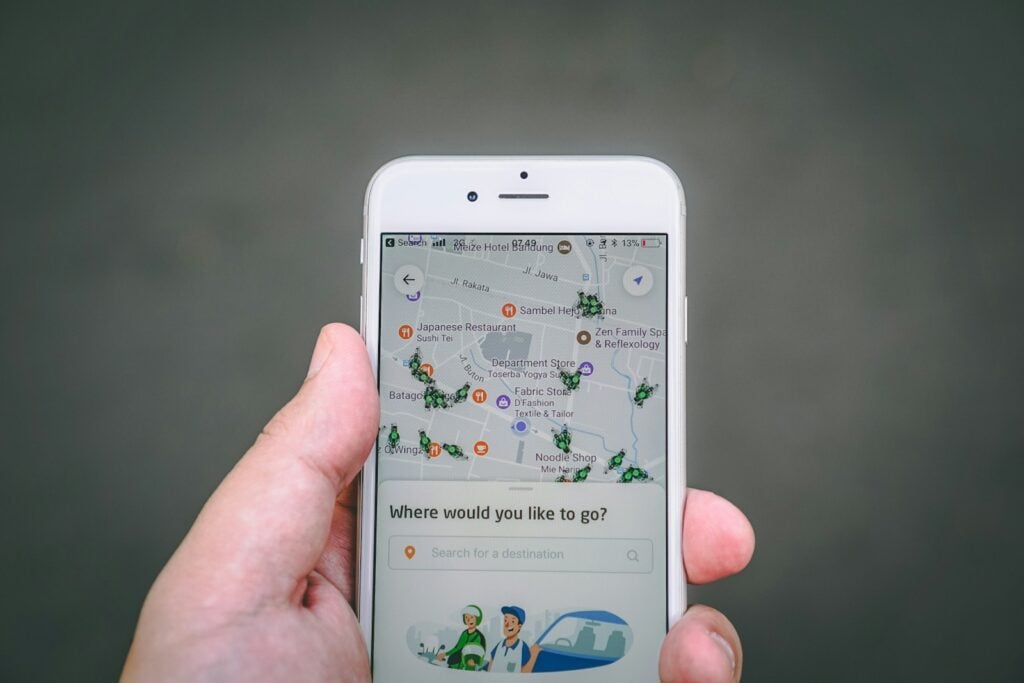 Person booking a ride on a ride-hailing app on a smartphone