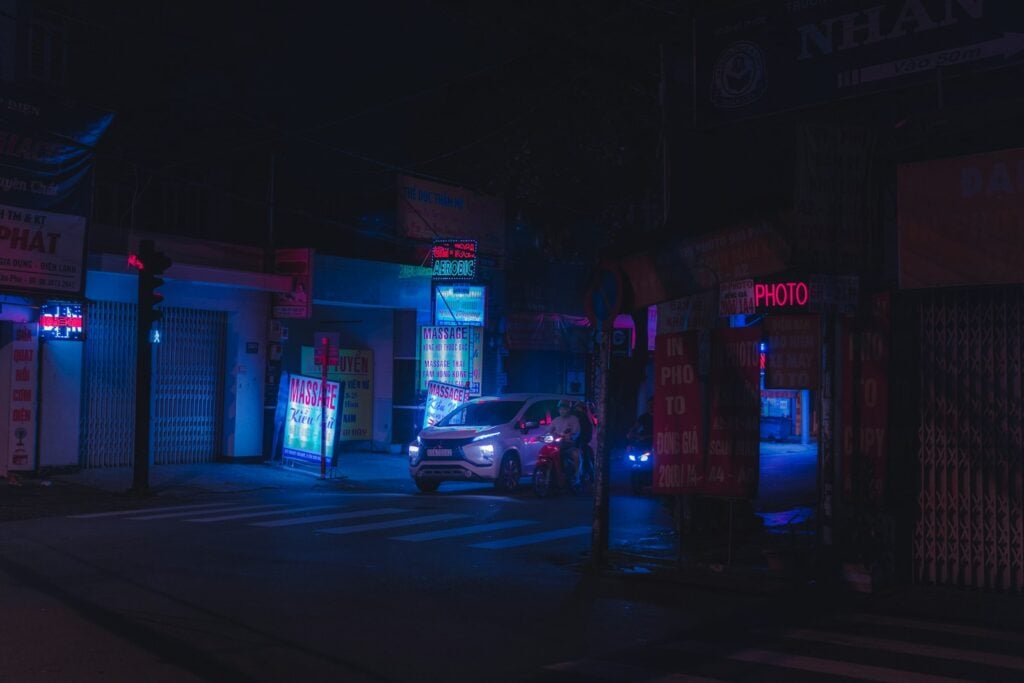 Cars parked in front of a store at night