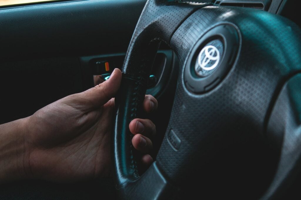 Driver with both hands on the steering wheel