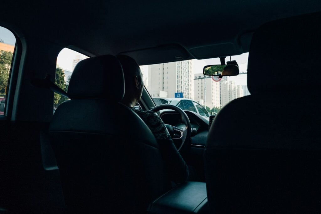 Driver behind the wheel of a car at night